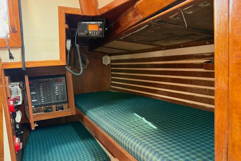 Slide: The Image of Interior of 1977 Cheoy Lee Offshore 41 ketch with control panel and green plaid cushions. - 15