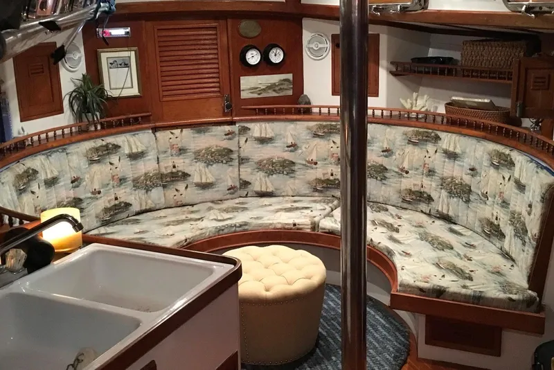 Slide: The Image of Interior of 1977 Cheoy Lee Offshore 41 ketch with nautical-themed seating and wooden accents. - 6