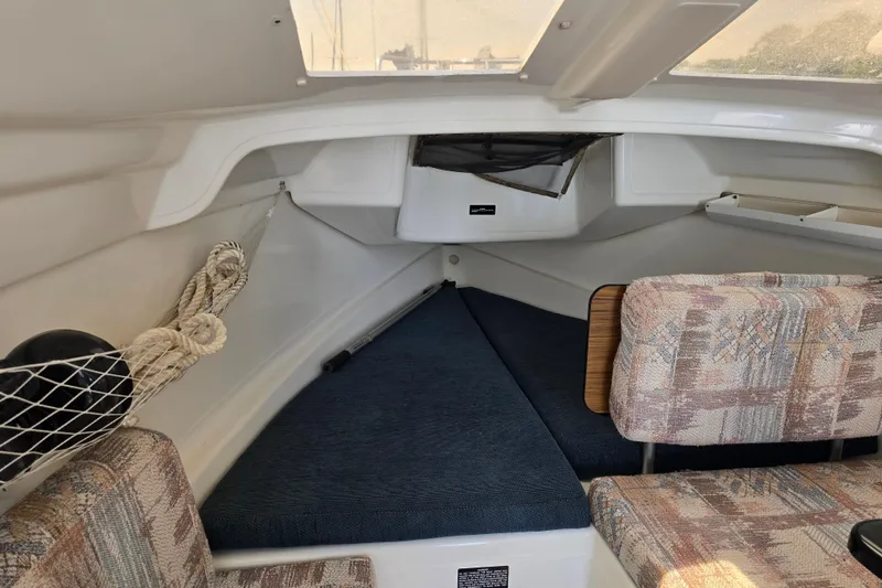 Slide: The Image of Interior of 2002 MacGregor 26X Powersailer with seating and storage. - 12