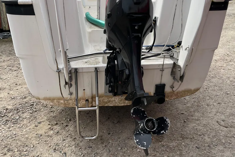 Slide: The Image of Rear view of 2002 MacGregor 26X Powersailer with outboard motor and ladder. - 18