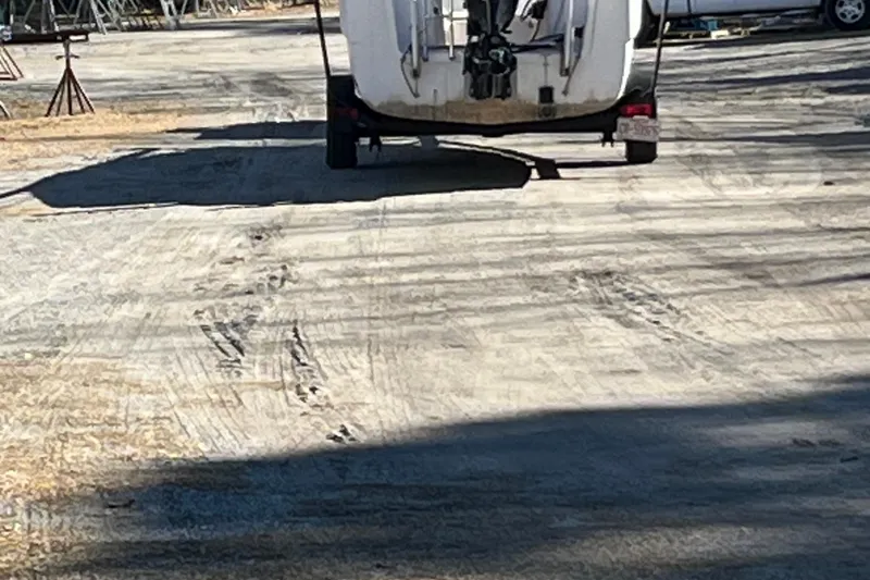Slide: The Image of 2002 MacGregor 26X Powersailer on trailer in a boatyard. - 20