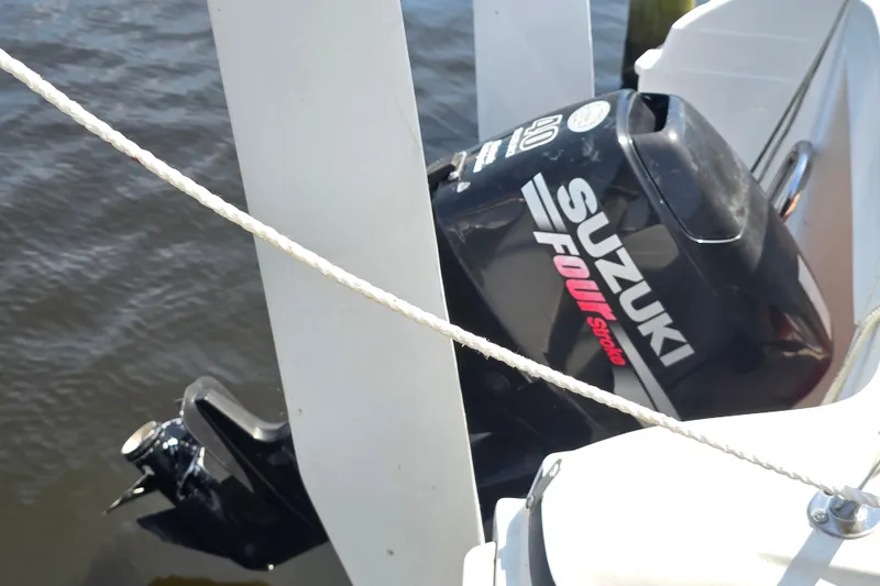 Slide: The Image of Outboard motor on 2002 MacGregor 26X Powersailer, featuring Suzuki Four Stroke engine. - 7