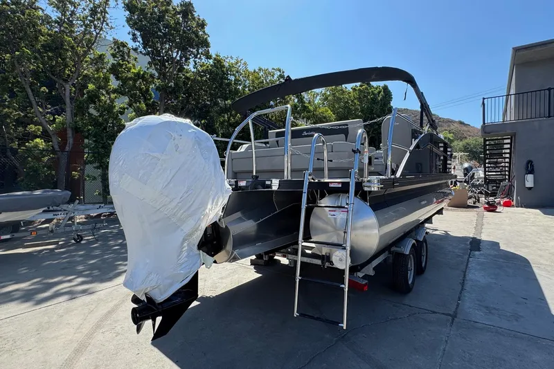 Slide: The Image of 2026 Barletta ARIA 22UC pontoon boat on trailer, parked outdoors. - 11