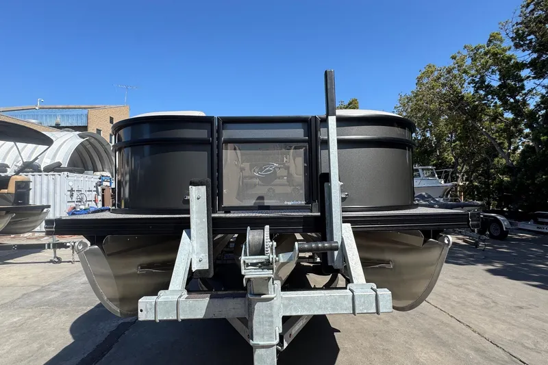 Slide: The Image of 2026 Barletta ARIA 22UC pontoon boat on trailer, parked outdoors under clear blue sky. - 16