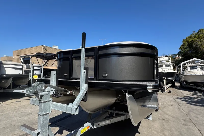 Slide: The Image of 2026 Barletta ARIA 22UC pontoon boat on trailer, displayed outdoors under clear blue sky. - 17