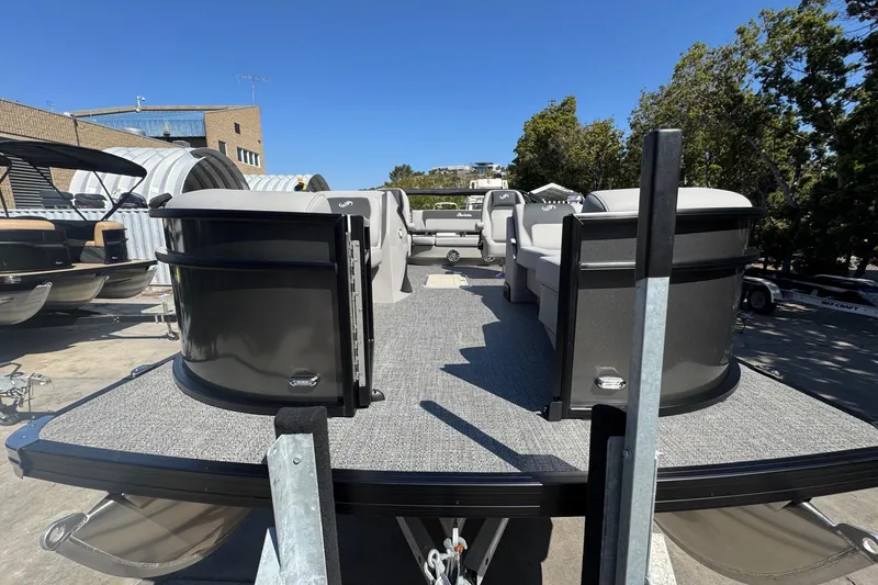 Slide: The Image of 2026 Barletta ARIA 22UC pontoon boat with spacious seating, docked outdoors. - 19