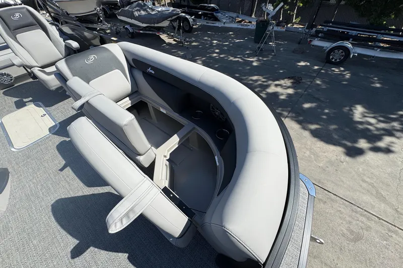 Slide: The Image of 2026 Barletta ARIA 22UC boat interior with plush seating and cup holders. - 23