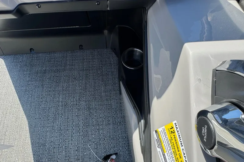 Slide: The Image of Interior of 2026 Barletta ARIA 22UC boat showing throttle and cup holder. - 43