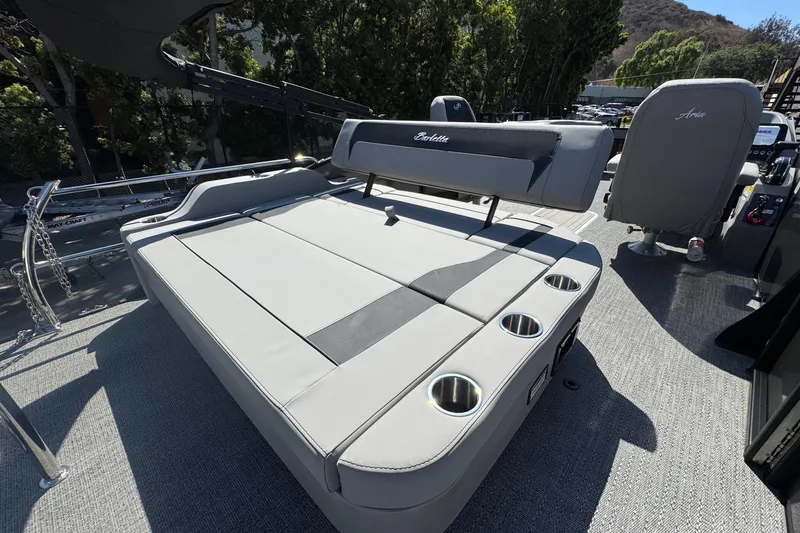 Slide: The Image of 2026 Barletta ARIA 22UC boat interior with cushioned seating and cup holders. - 52