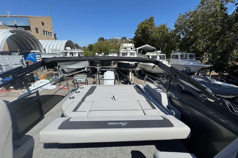 Slide: The Image of 2026 Barletta ARIA 22UC pontoon boat with sleek seating, docked in a marina. - 53