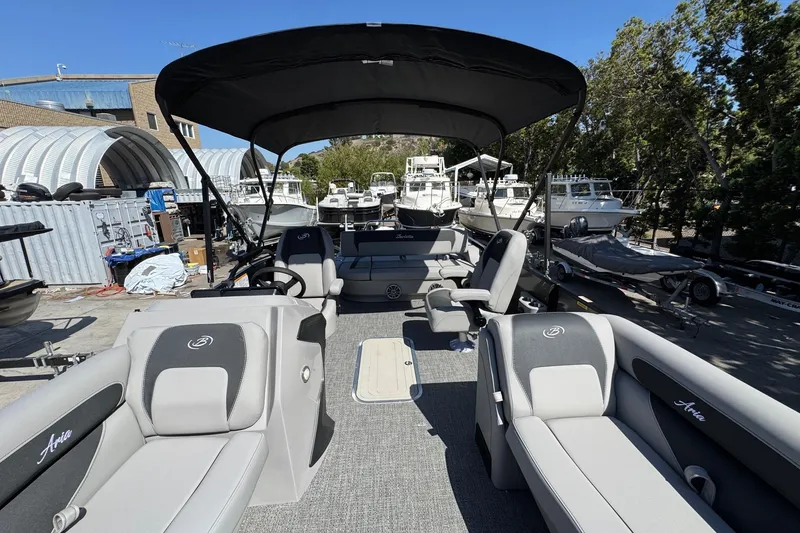 Slide: The Image of 2026 Barletta ARIA 22UC pontoon boat with spacious seating and canopy in a marina. - 64