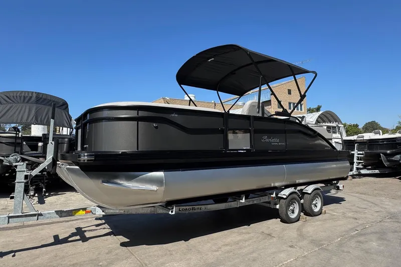 Slide: The Image of 2026 Barletta ARIA 22UC pontoon boat on trailer under clear blue sky. - 67