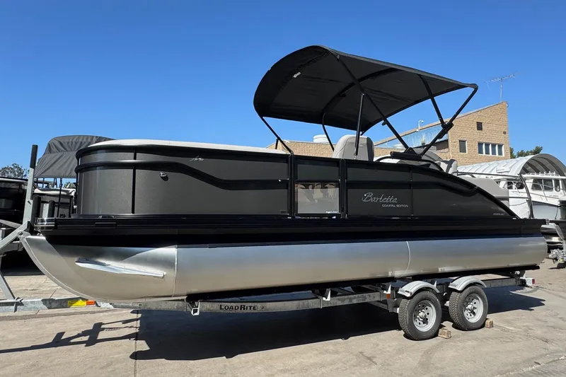 Slide: The Image of 2026 Barletta ARIA 22UC pontoon boat on trailer, featuring sleek design and canopy. - 68