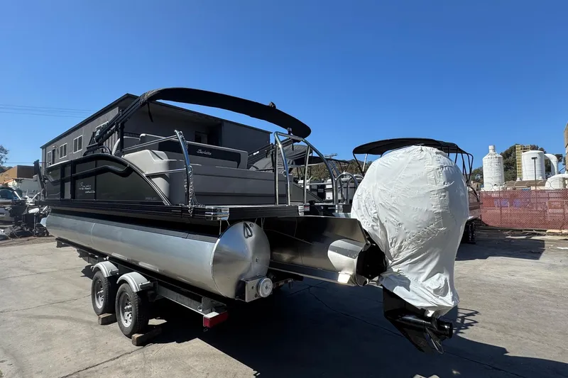 Slide: The Image of 2026 Barletta ARIA 22UC pontoon boat on trailer, outdoor setting, clear sky. - 8