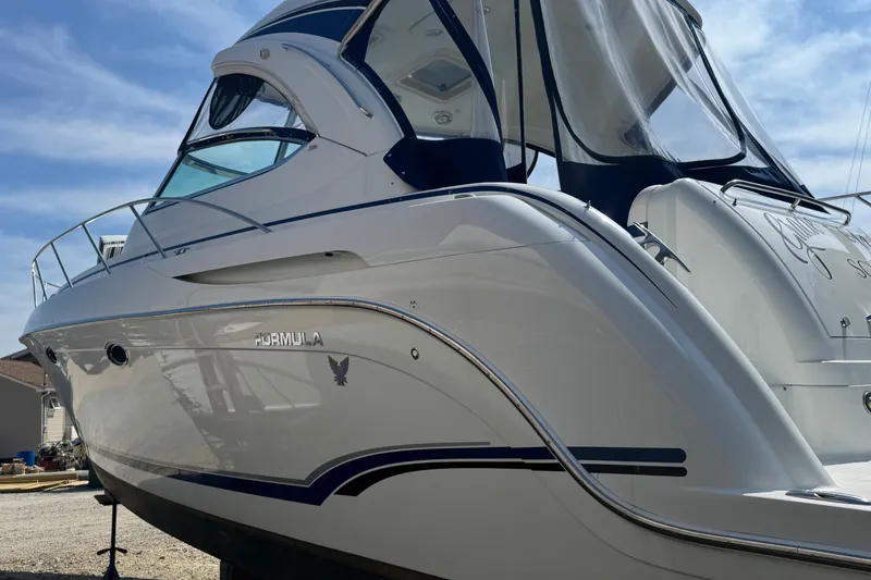 Slide: The Image of 2011 Formula 37 Performance Cruiser, sleek white design, docked under clear blue sky. - 1