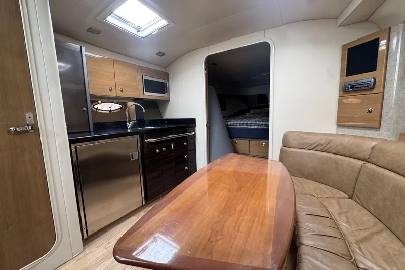 Slide: The Image of 2011 Formula 37 Performance Cruiser interior with kitchen, seating, and sleeping area. - 18