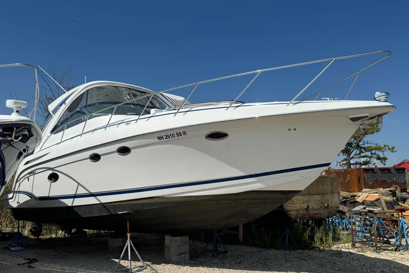 Slide: The Image of 2011 Formula 37 Performance Cruiser on stands, white hull, clear blue sky background. - 2