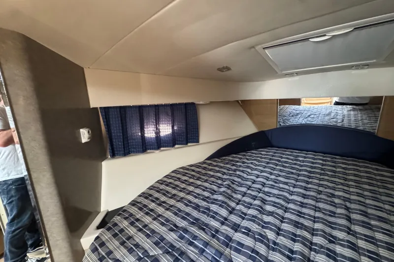Slide: The Image of Interior cabin of 2011 Formula 37 Performance Cruiser with striped bedding and blue curtains. - 29