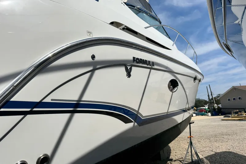 Slide: The Image of 2011 Formula 37 Performance Cruiser boat on land, showcasing sleek design and branding. - 3