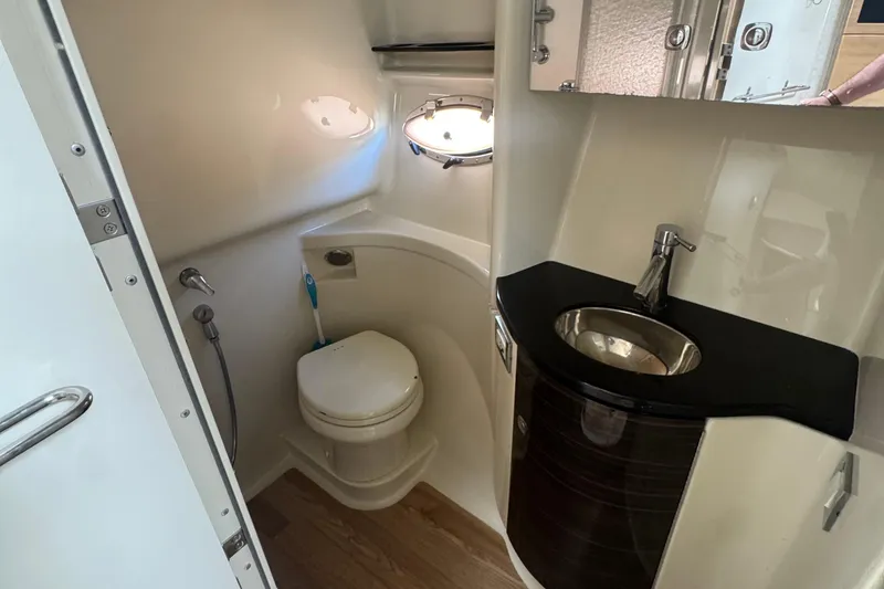 Slide: The Image of 2011 Formula 37 Performance Cruiser bathroom with toilet, sink, and mirror. - 31