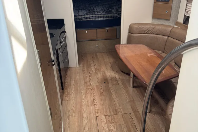 Slide: The Image of 2011 Formula 37 Performance Cruiser interior with wood flooring, kitchenette, and seating area. - 34