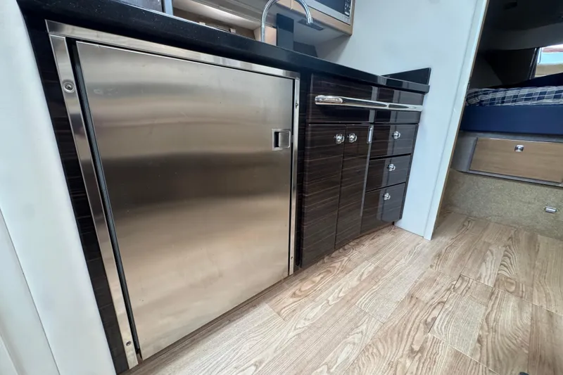 Slide: The Image of 2011 Formula 37 Performance Cruiser interior with sleek cabinetry and stainless steel fridge. - 35