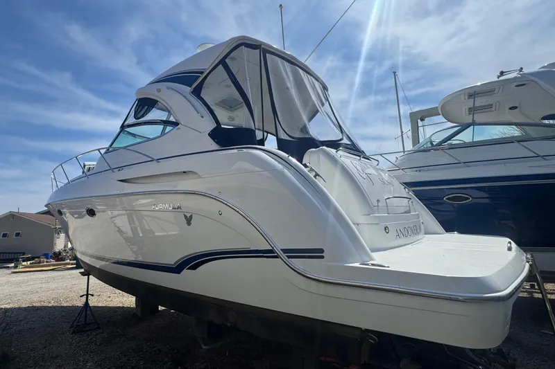 Slide: The Image of 2011 Formula 37 Performance Cruiser boat on dry dock under a clear blue sky. - 4