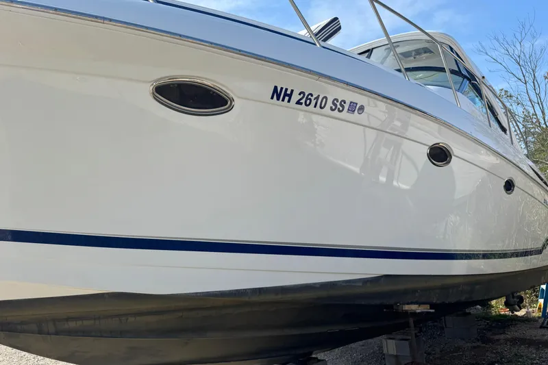 Slide: The Image of 2011 Formula 37 Performance Cruiser boat on land, white hull with blue stripe. - 8