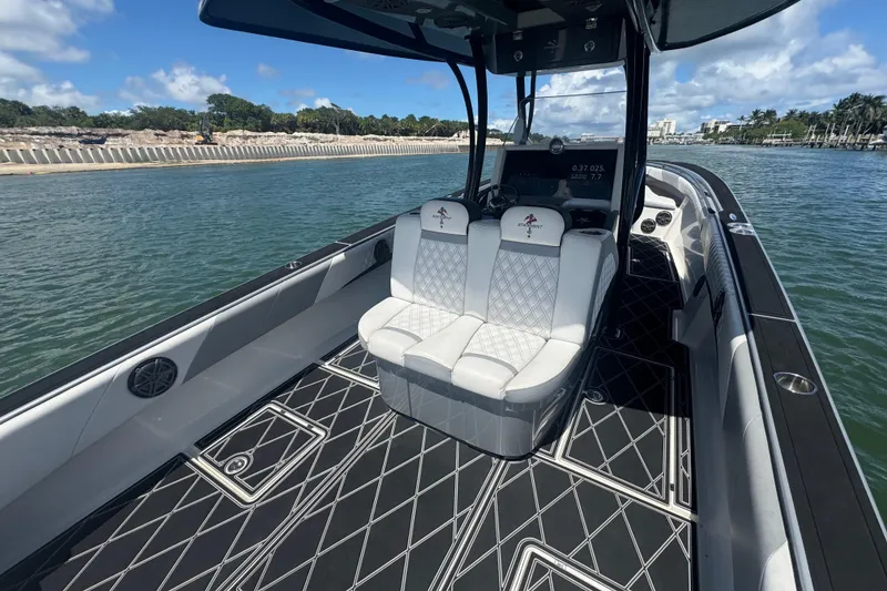 Slide: The Image of 2016 Statement 380 Open boat interior with luxury seating and sleek design on calm water. - 13