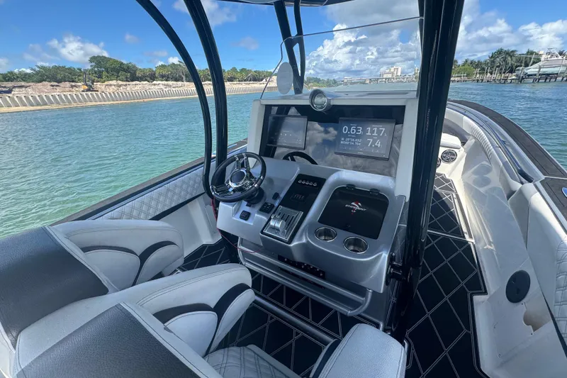 Slide: The Image of Cockpit view of 2016 Statement 380 Open boat with modern controls and scenic water backdrop. - 14