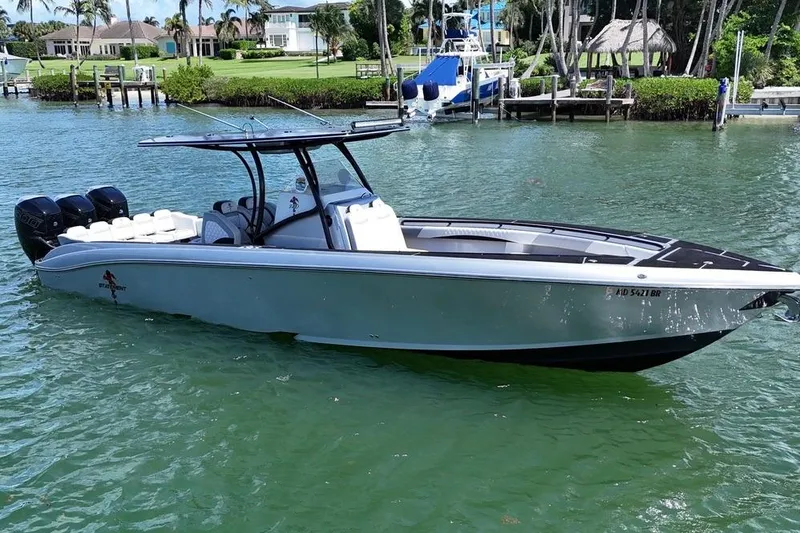 Slide: The Image of 2016 Statement 380 Open boat on water, featuring sleek design and triple outboard engines. - 5