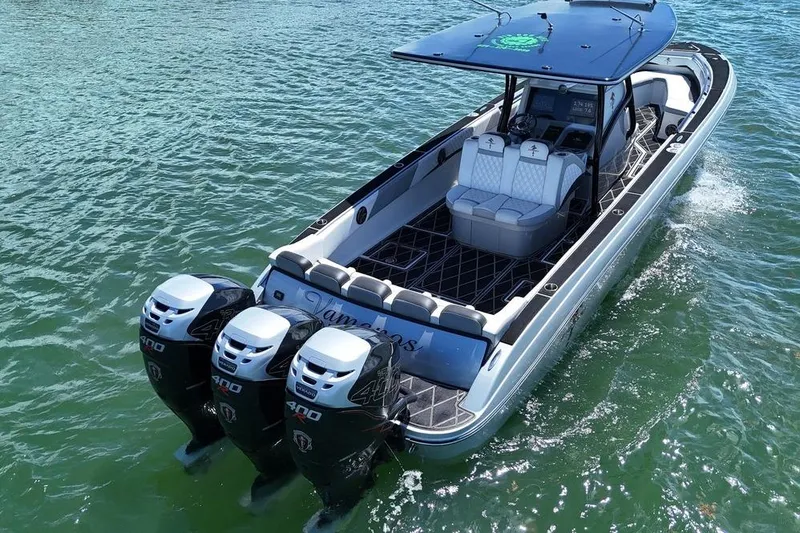 Slide: The Image of 2016 Statement 380 Open boat with triple 400 horsepower engines on water. - 8