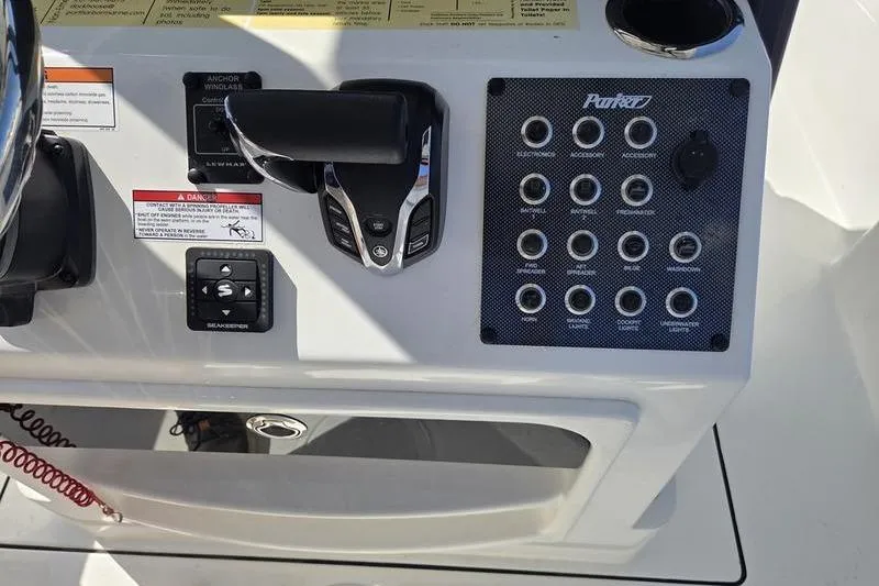 Slide: The Image of Control panel of 2025 Parker 2400 Center Console boat with switches and throttle. - 10