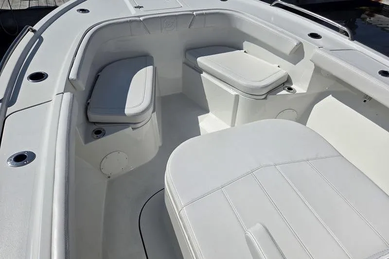 Slide: The Image of 2025 Parker 2400 Center Console boat interior with white cushioned seating. - 13