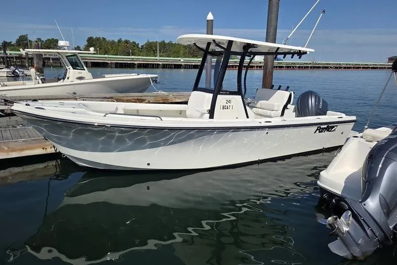 Slide: The Image of 2025 Parker 2400 Center Console boat docked in a marina under clear skies. - 5