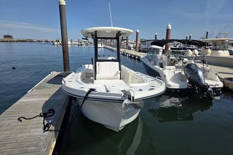 Slide: The Image of 2025 Parker 2400 Center Console boat docked at a marina on a sunny day. - 6