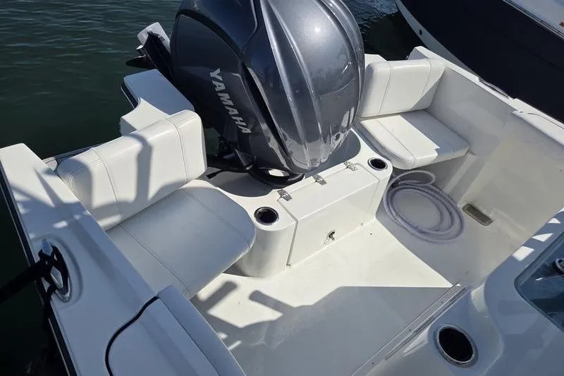 Slide: The Image of 2025 Parker 2400 Center Console boat with Yamaha engine, featuring spacious seating and cup holders. - 8