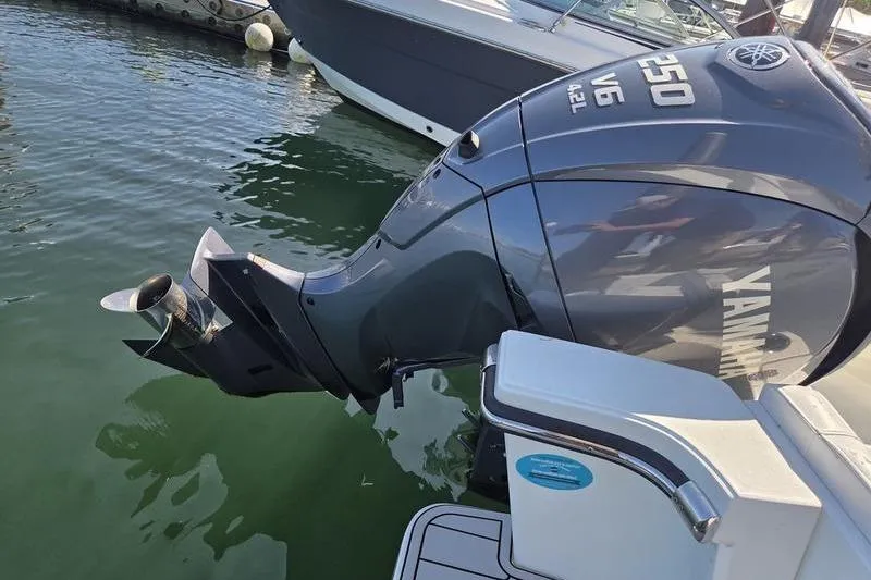 Slide: The Image of Outboard motor on a 2025 Parker 2400 Center Console boat, docked in water. - 9