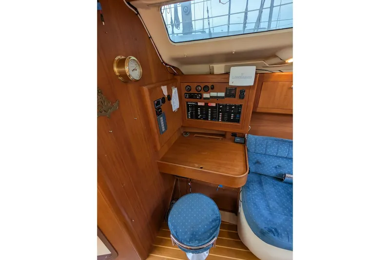 Slide: The Image of 1998 Hunter 376 yacht interior with navigation station and blue seating. - 15