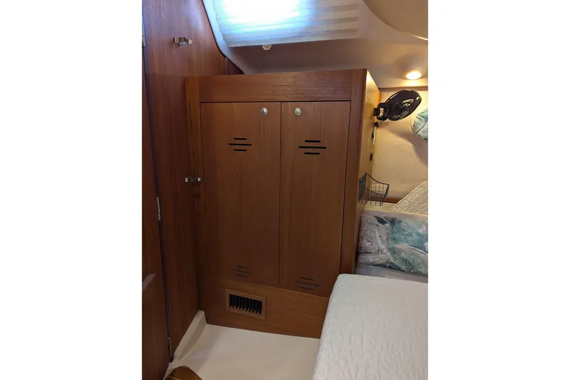 Slide: The Image of Interior of 1998 Hunter 376 sailboat with wooden cabinetry and cozy bedding. - 24
