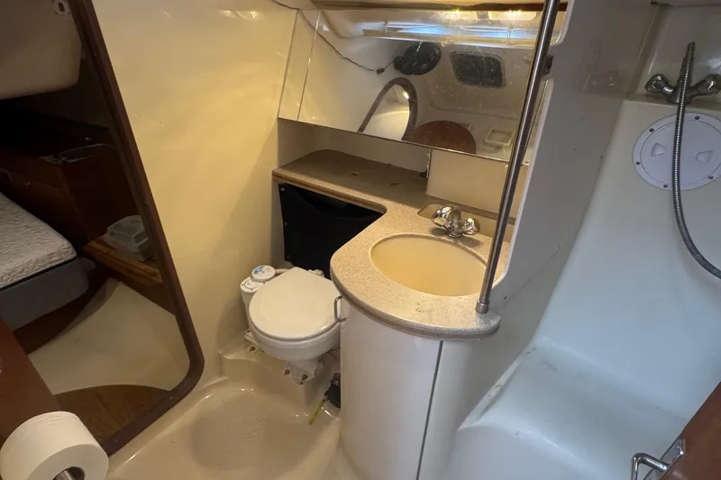 Slide: The Image of 1998 Hunter 376 yacht bathroom with sink, toilet, and shower area. - 33