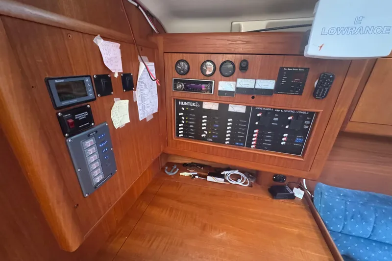 Slide: The Image of Control panel of a 1998 Hunter 376 sailboat with navigation and electrical systems. - 34