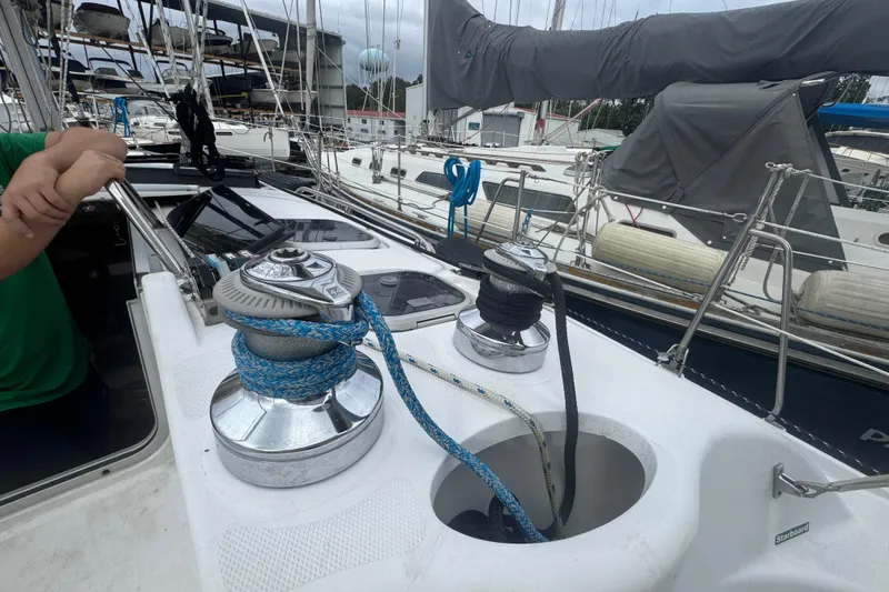 Slide: The Image of Sailboat deck with winches and ropes, Hunter 376, 1998 model, marina background. - 35