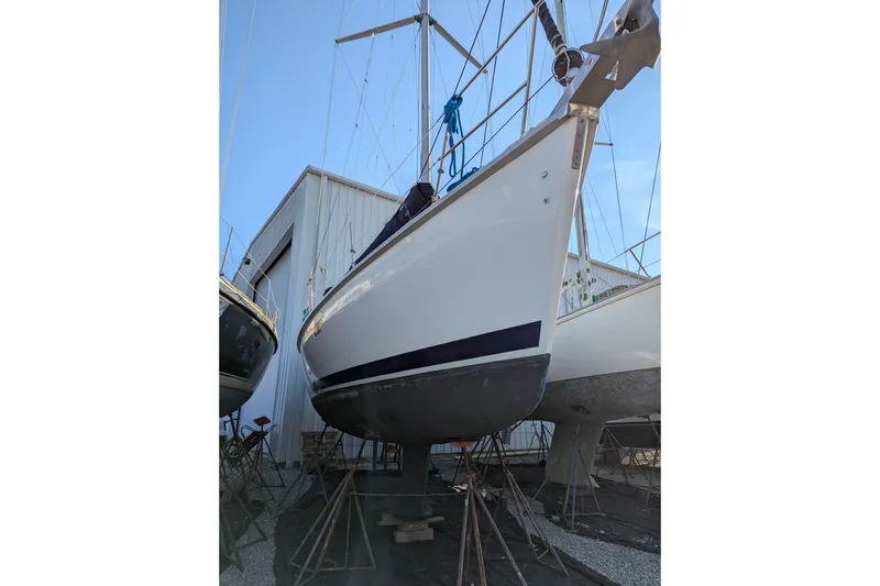 Slide: The Image of 1998 Hunter 376 sailboat on stands in a boatyard, ready for maintenance. - 41