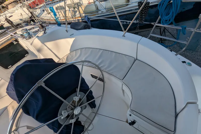 Slide: The Image of Cockpit of a 1998 Hunter 376 sailboat with covered steering wheel and seating. - 46