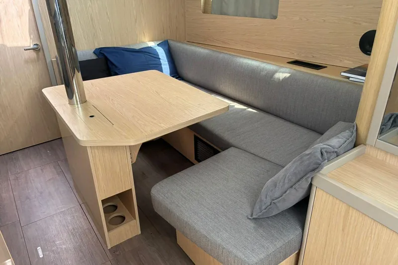 Slide: The Image of Interior of 2020 Beneteau Oceanis 41.1 yacht with modern seating and wooden table. - 3