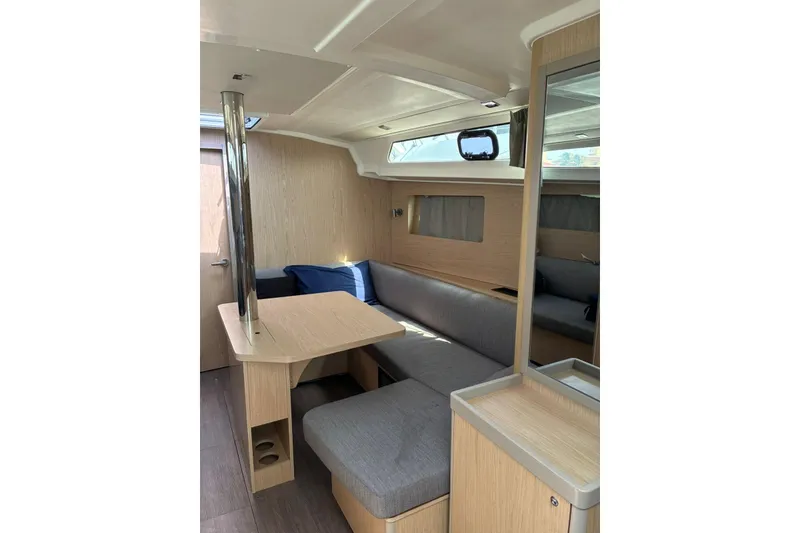 Slide: The Image of Modern interior of 2020 Beneteau Oceanis 41.1 yacht with cozy seating and wooden finishes. - 5
