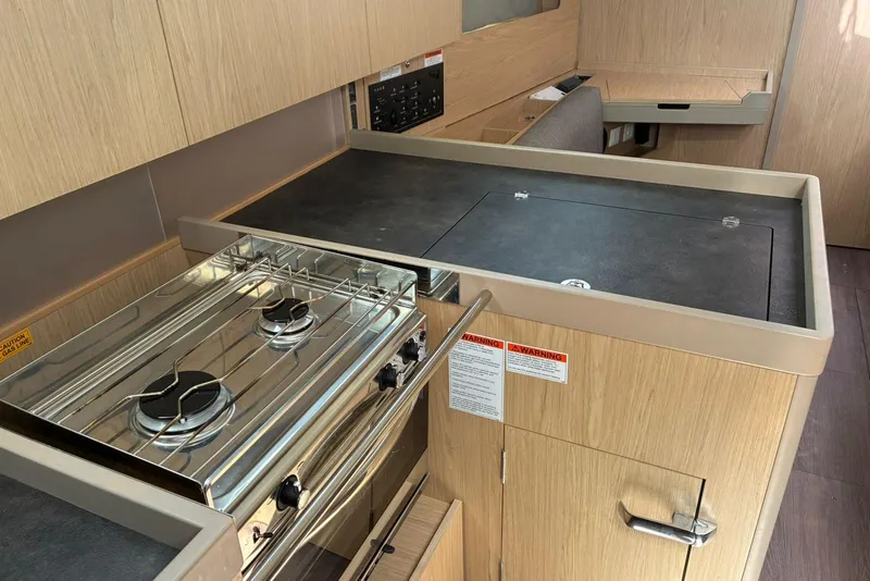 Slide: The Image of Modern kitchen in 2020 Beneteau Oceanis 41.1 yacht with stove and sleek cabinetry. - 7