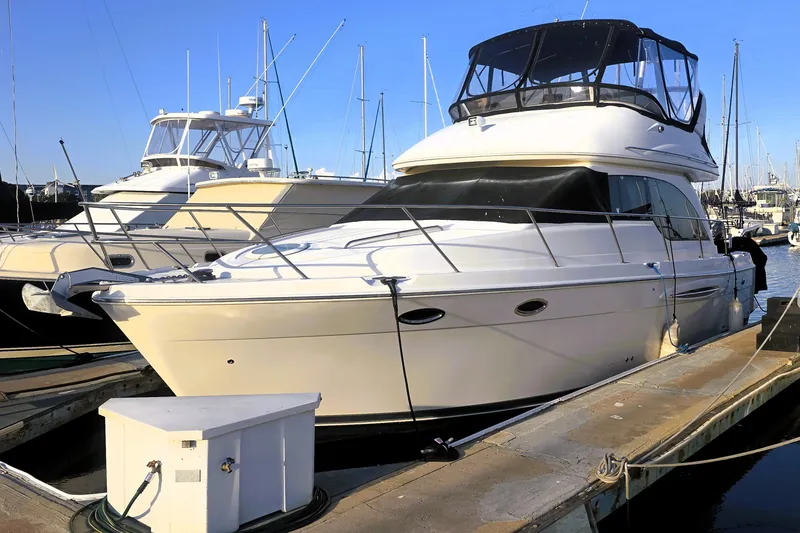 Slide: The Image of 2004 Meridian 391 Sedan yacht docked at marina, surrounded by other boats. - 1