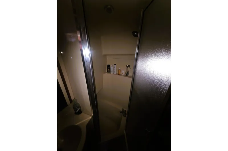 Slide: The Image of Shower area in 2004 Meridian 391 Sedan yacht bathroom with toiletries. - 13